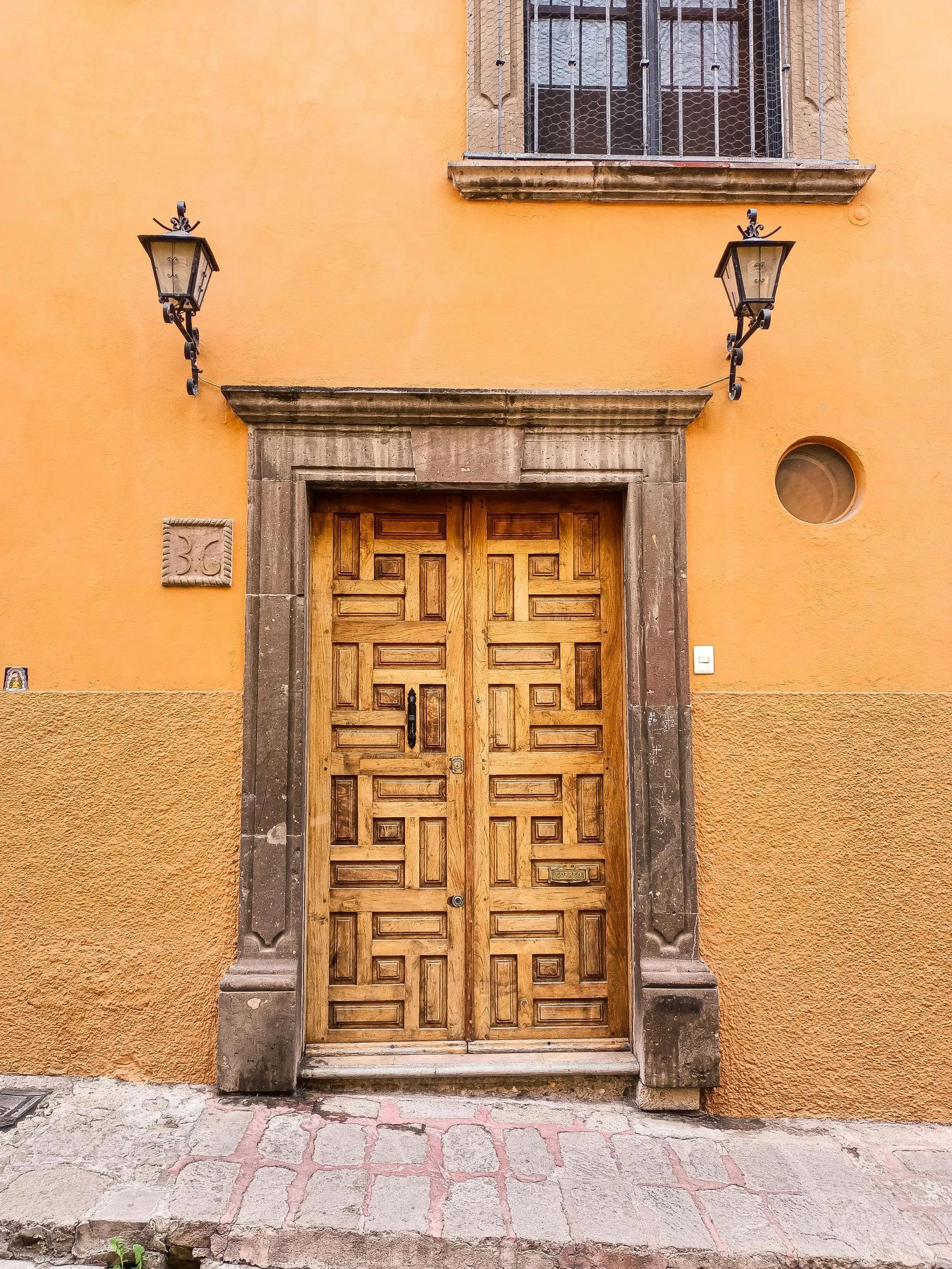 the door is wooden and is in front of a building