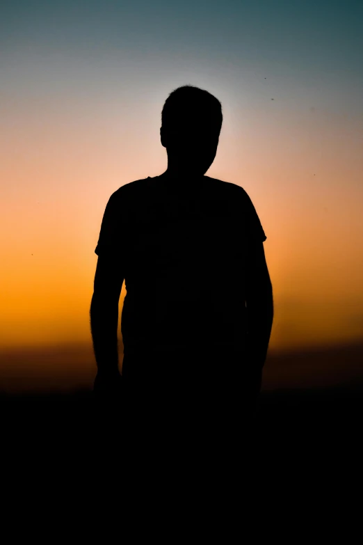 a man standing next to the beach during sunset