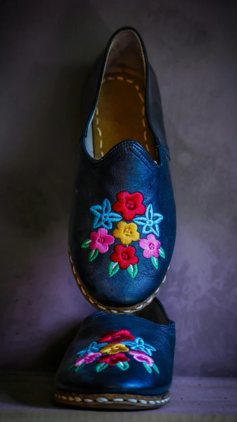 there is a blue pair with embroidered flowers on it