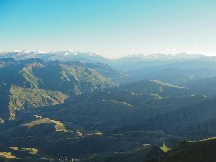 a view of the mountains from top of a hill