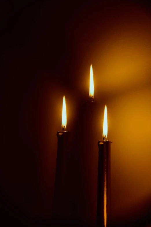 a candle on the wall with some lights