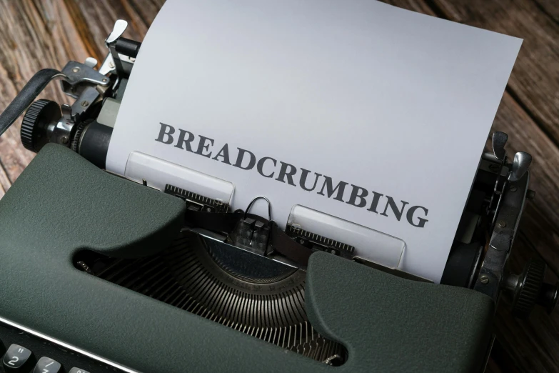 an old fashioned green typewriter with a sheet of paper on it