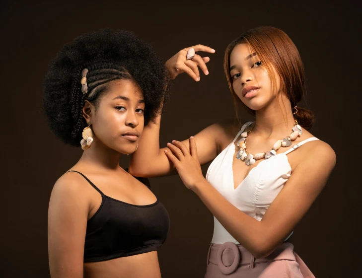 two girls posing in clothes for a portrait