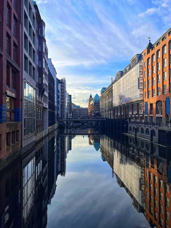 a small canal running through between tall buildings