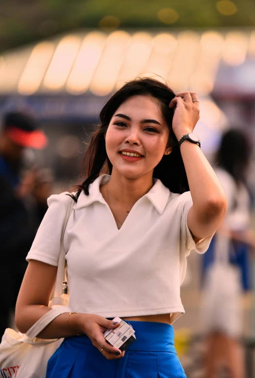 the woman is posing for the camera with her hand over her head