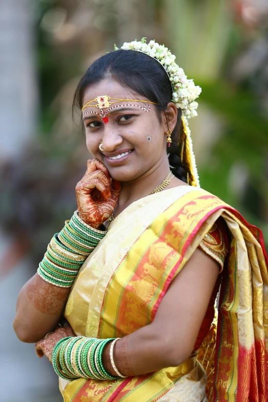 a woman in a yellow sari talking on the phone