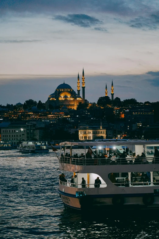 a river boat in front of a large city skyline