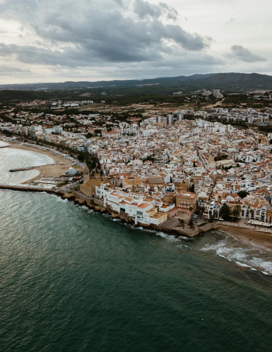 an aerial view of a city next to the ocean