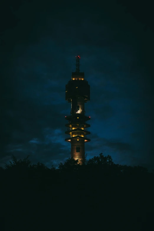 a tall tower in the night with a clock