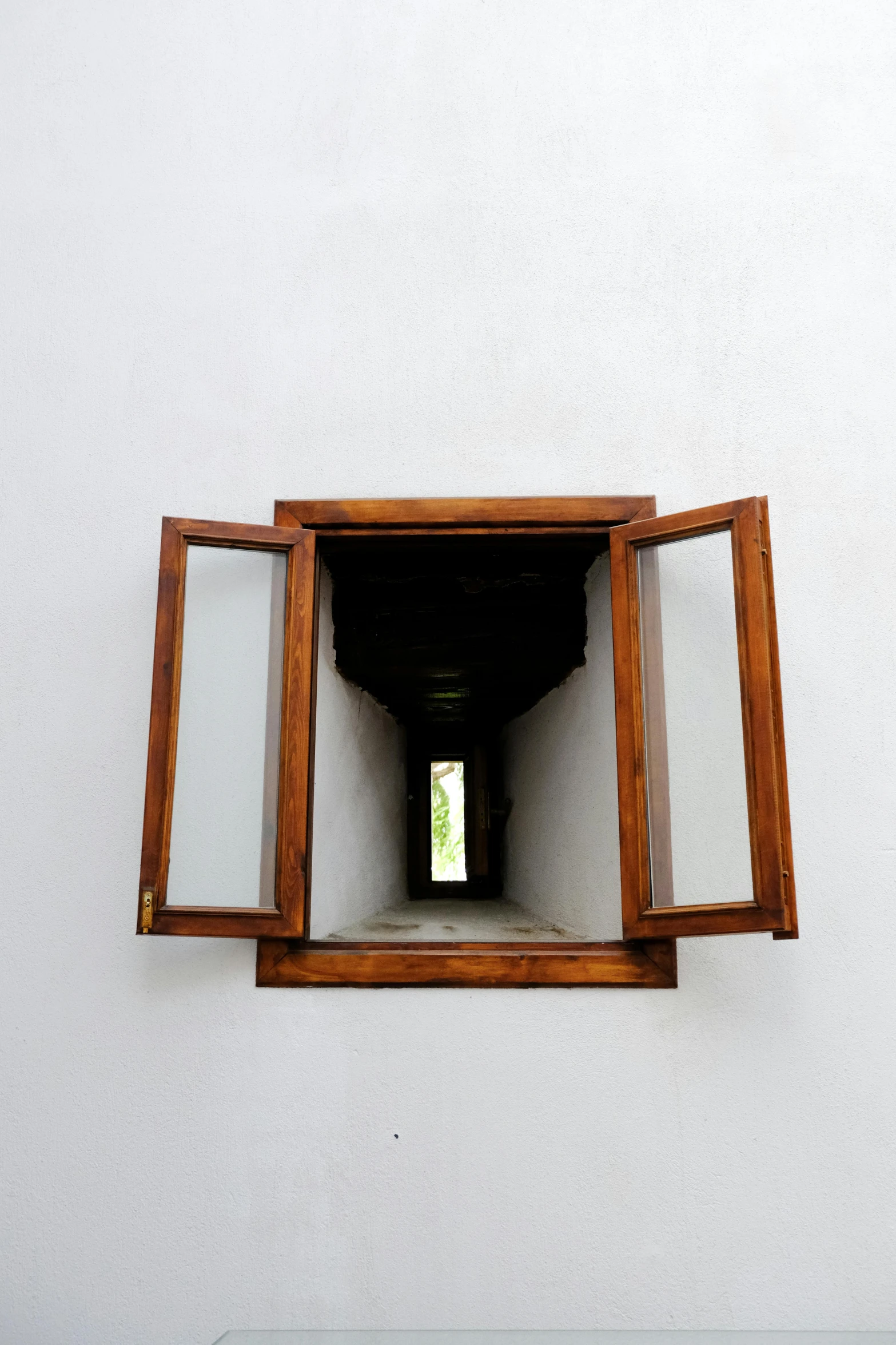 an open window in a white wall with a small opening