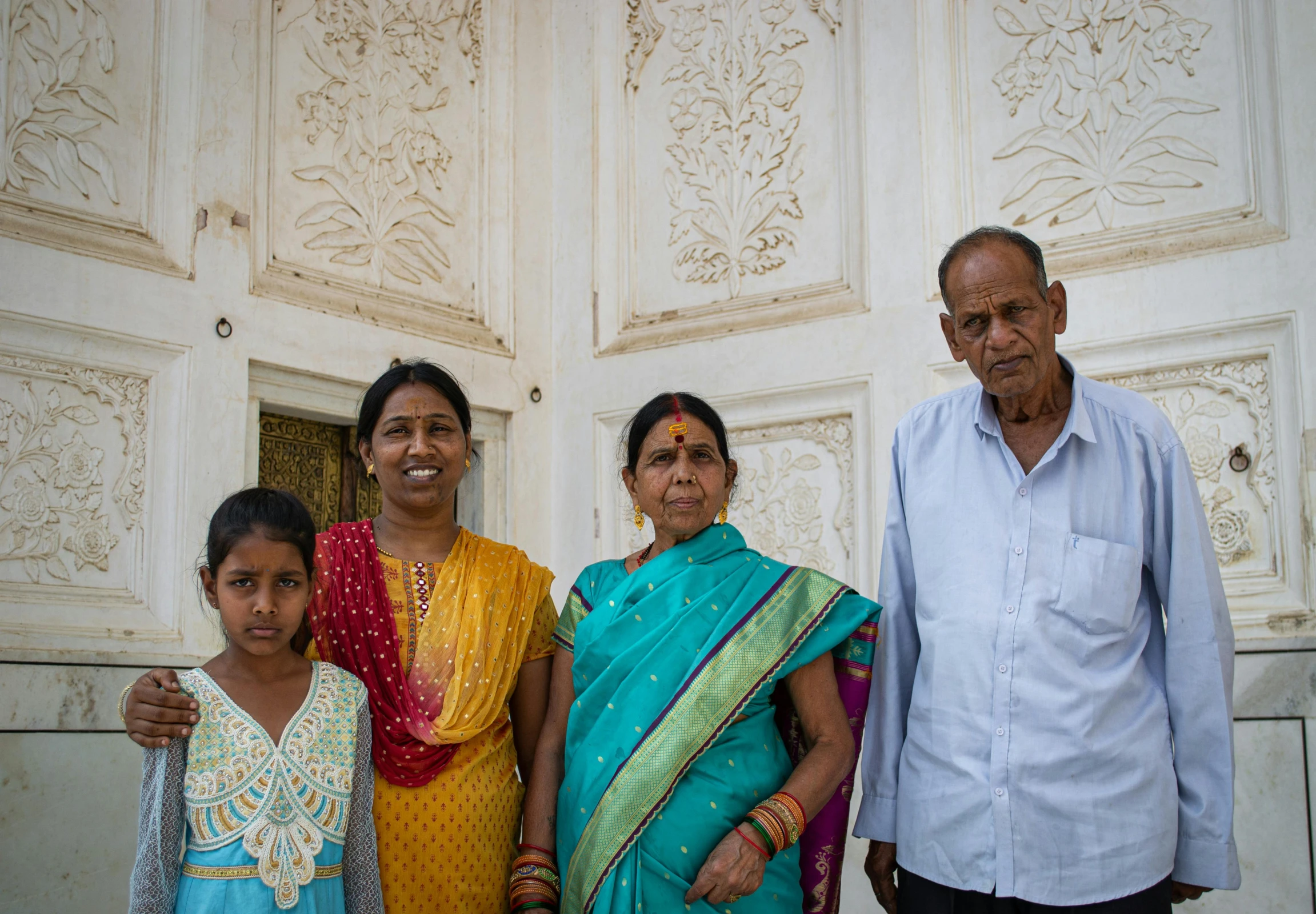 several people in sari are standing next to each other