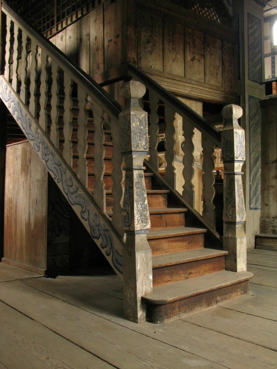 a very ornate wooden stair case with a number of steps