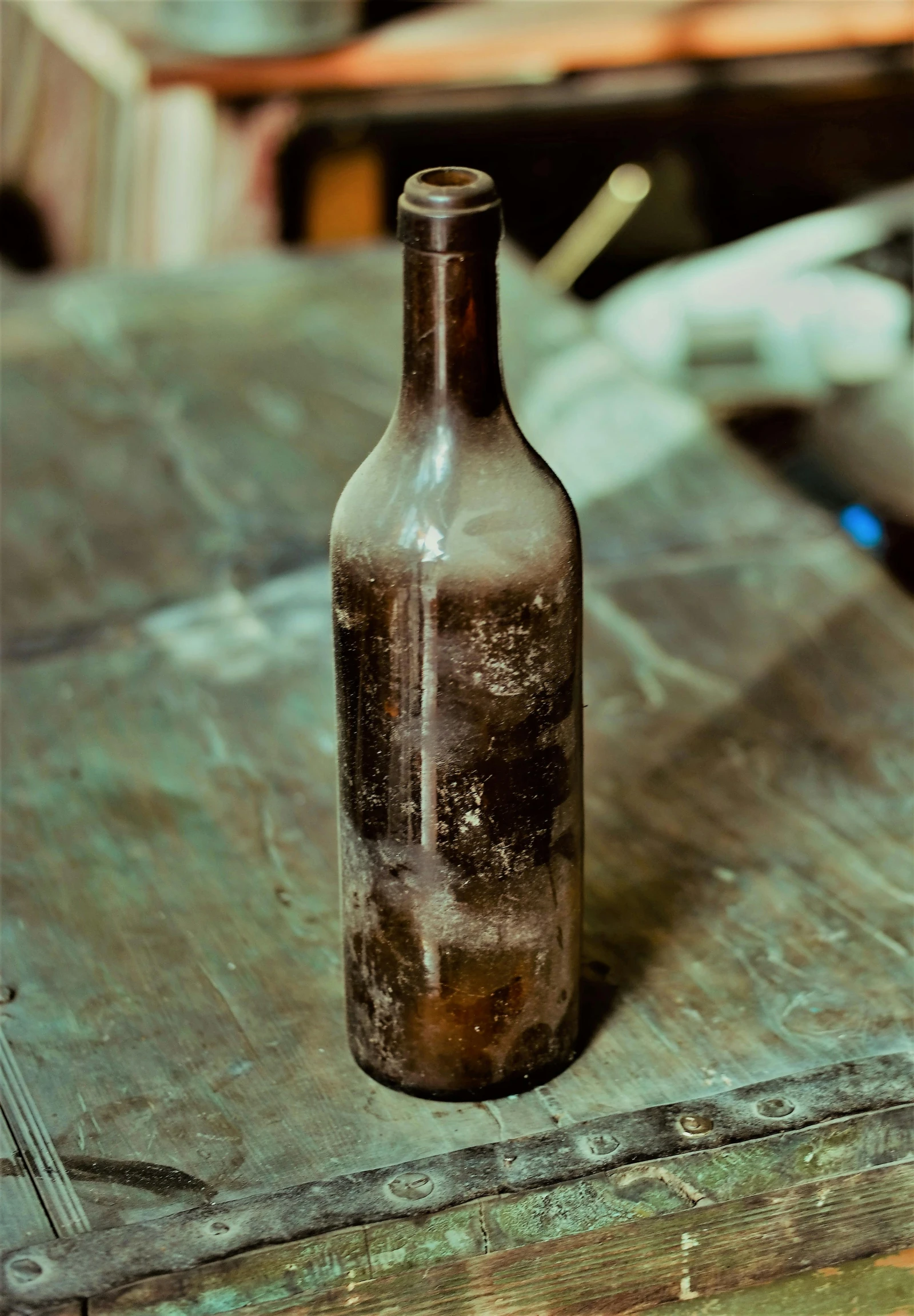 a brown bottle sitting on top of a wooden table