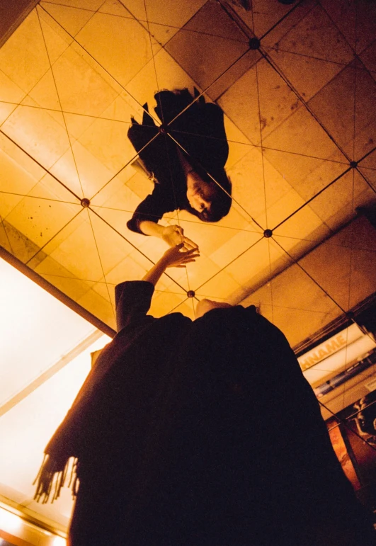 man kissing his head under a ceiling fixture