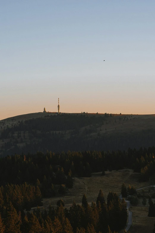 the distant sky and tower on top of a mountain