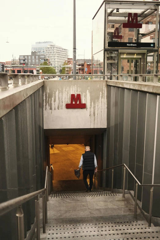 a man walking out of a tunnel on top of stairs