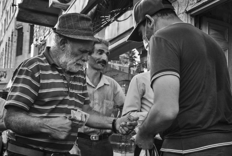 two men in a hat are standing next to each other