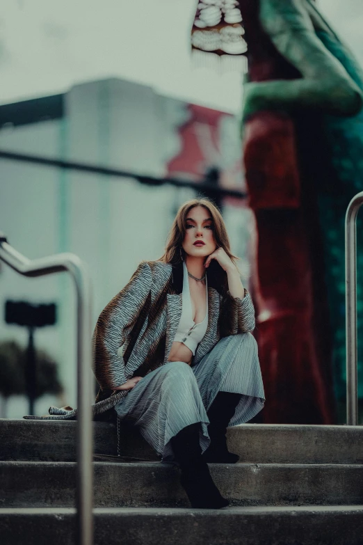 a woman sitting on top of some steps near a building