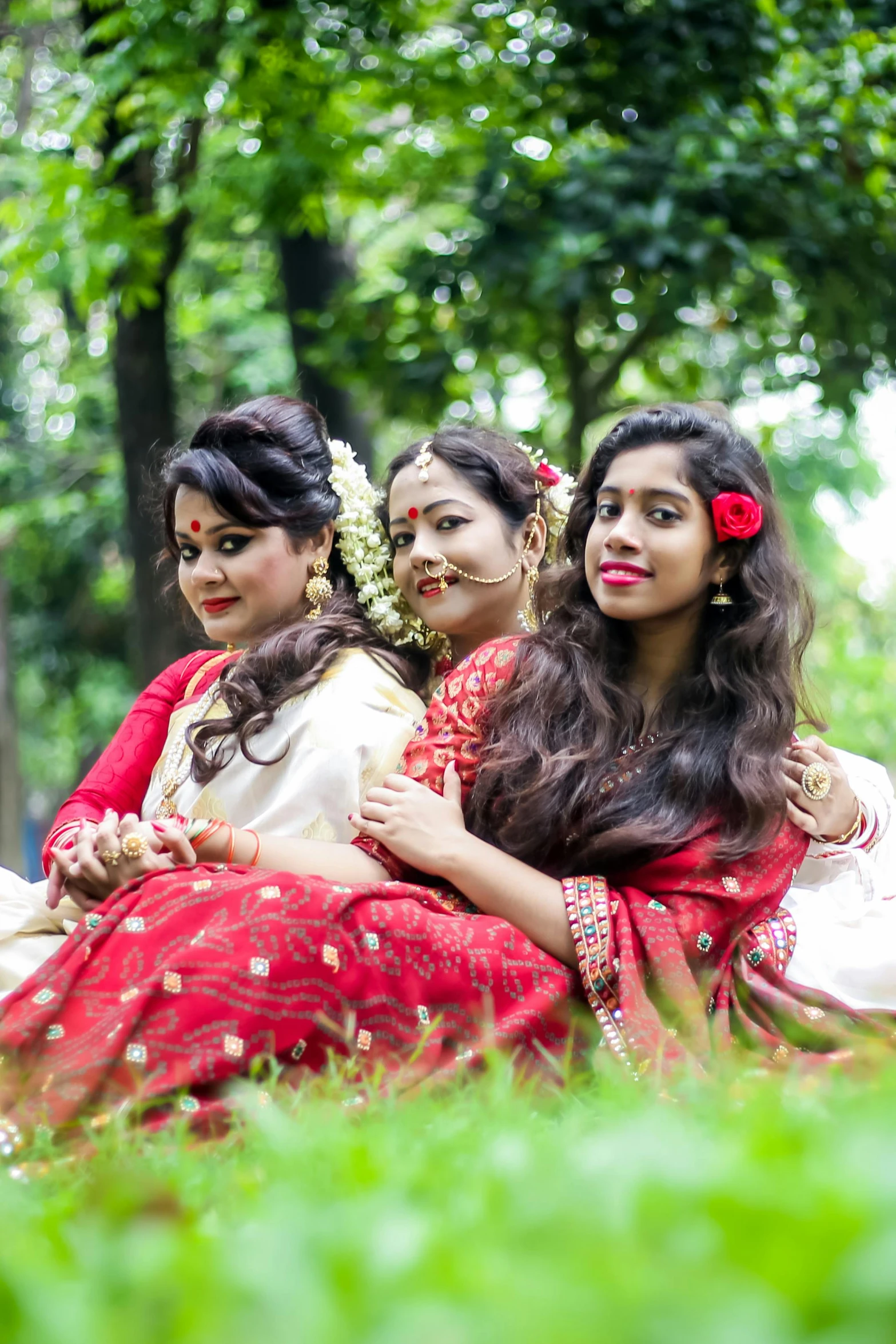 three women dressed in red are sitting down