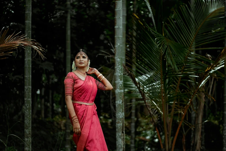 woman dressed in a red dress posing for a picture