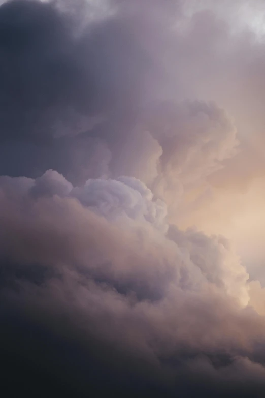 storm clouds form the backdrop as a plane flies in front