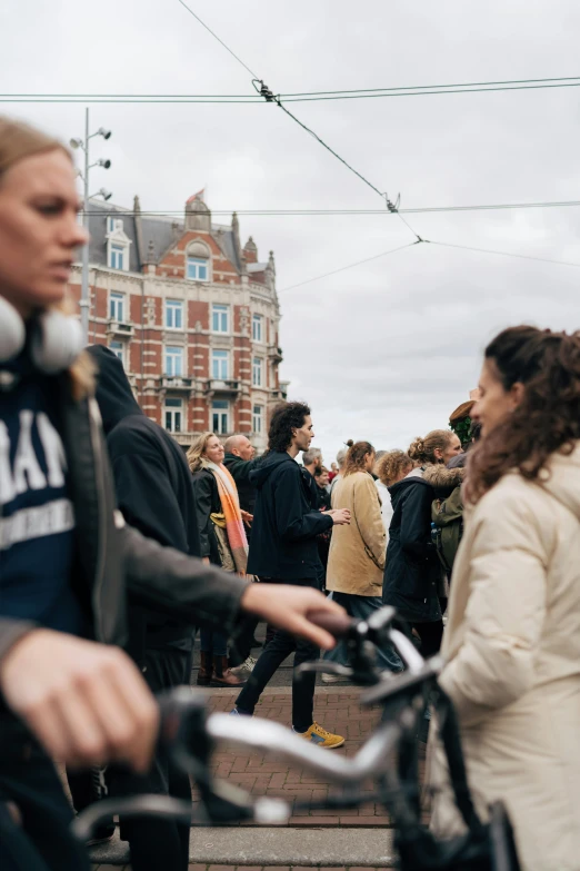 people walking, standing and sitting next to bicycles