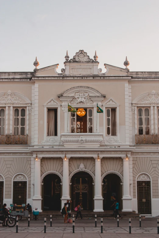 a large, old style building with a clock mounted on the wall