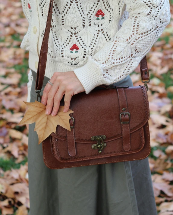 a woman holding a small bag on the ground