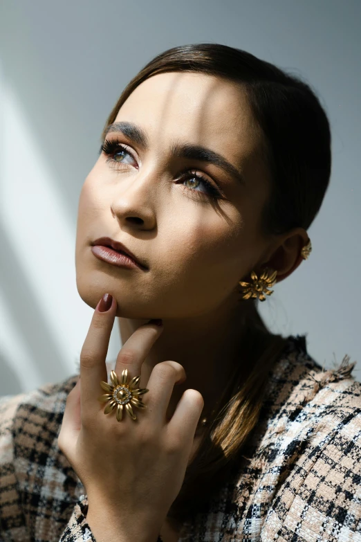 a woman wearing some earrings on her ring