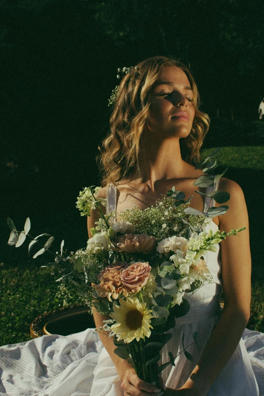 a woman wearing sun glasses and holding flowers