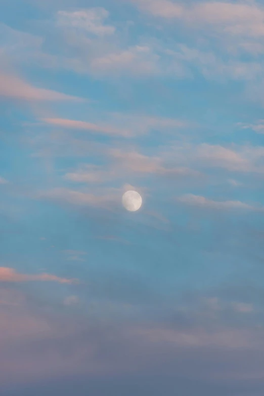 the moon seen in the background of a cloudy sky