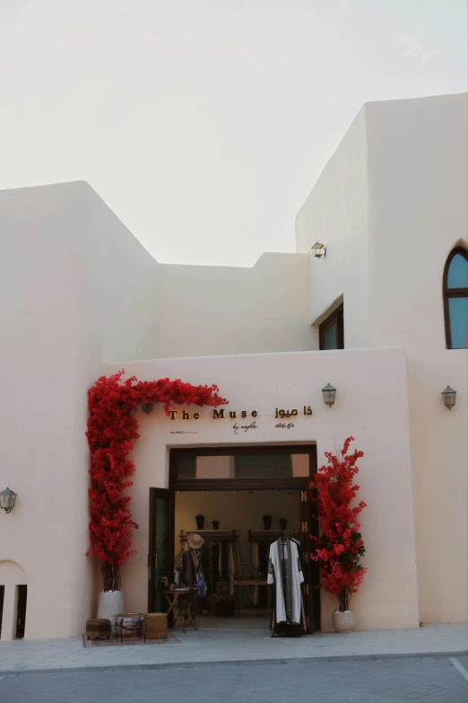 a woman standing in a doorway next to a building