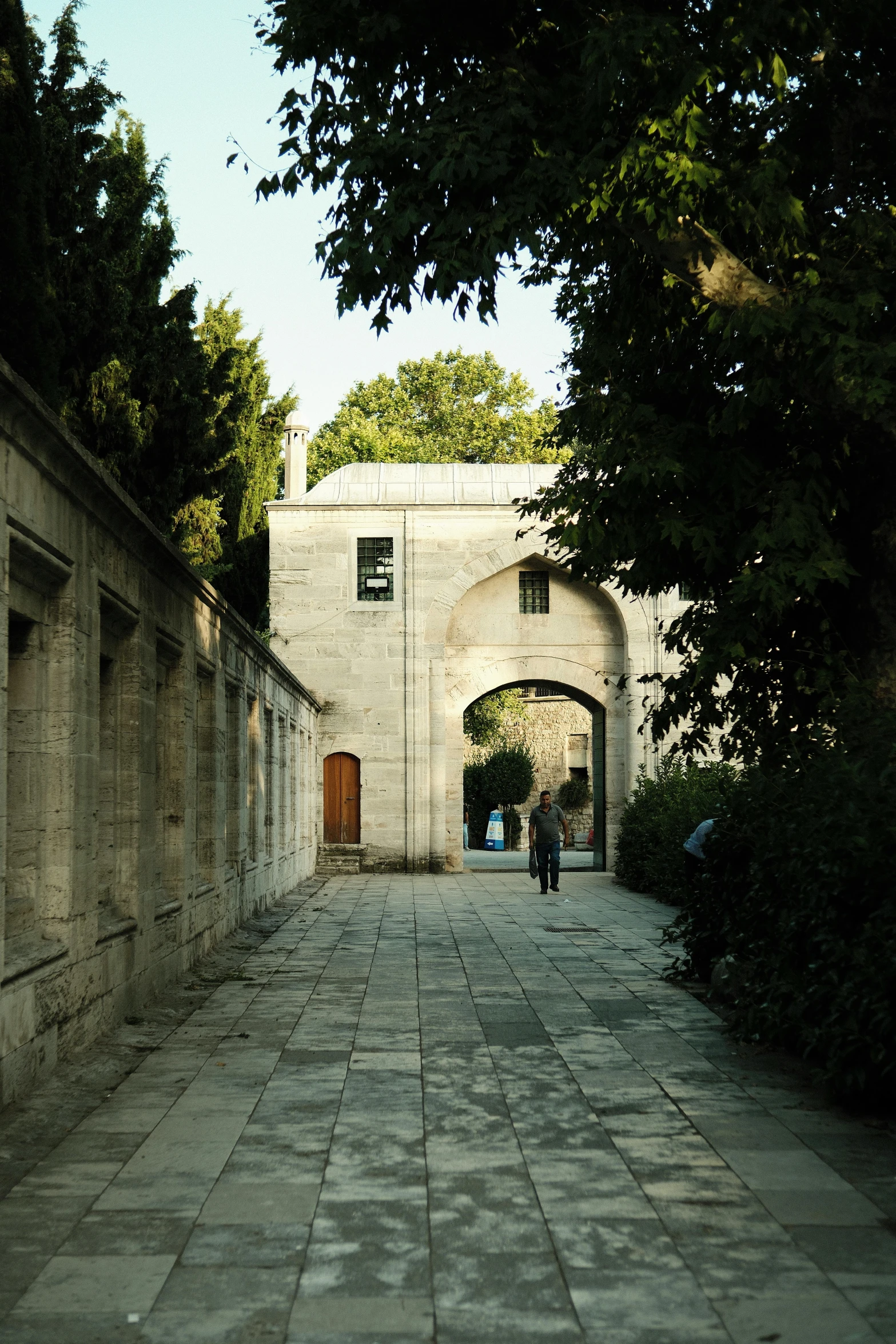 an arch leads into the courtyard area of a building