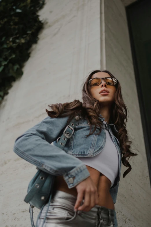 a person wearing sunglasses standing next to a building