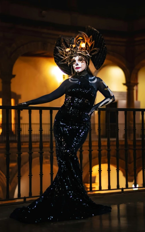 woman in a large hat posing in the dark