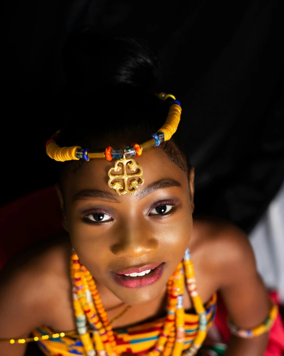 a woman with bright hair and colorful decorations on her head