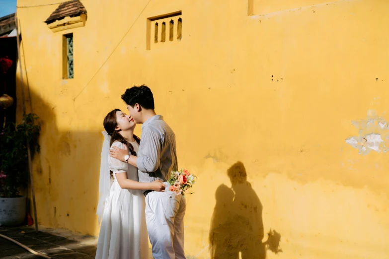 a man and woman standing outside by a building