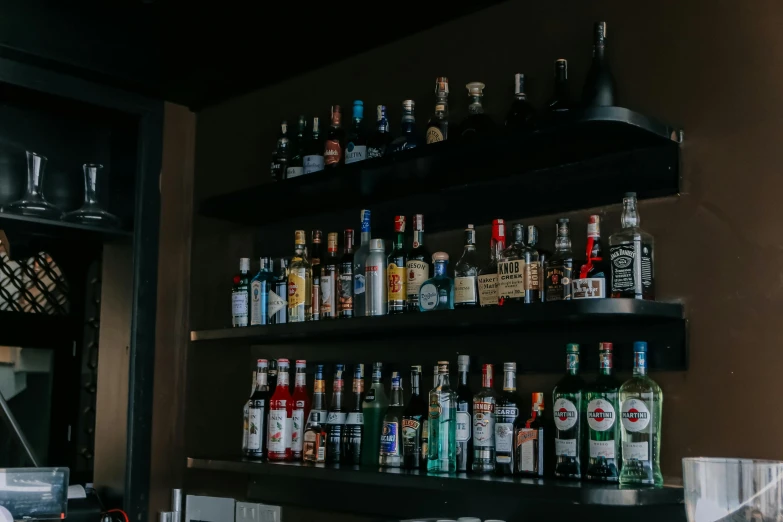 a long shelf full of different bottles on top of it