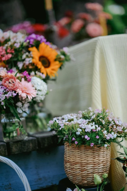 a close up of flowers in baskets and on the table