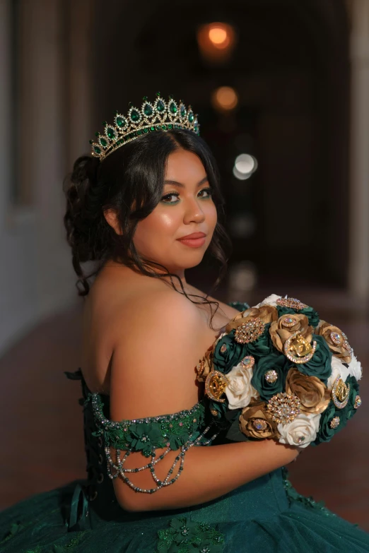 a woman in a green dress holding a bouquet