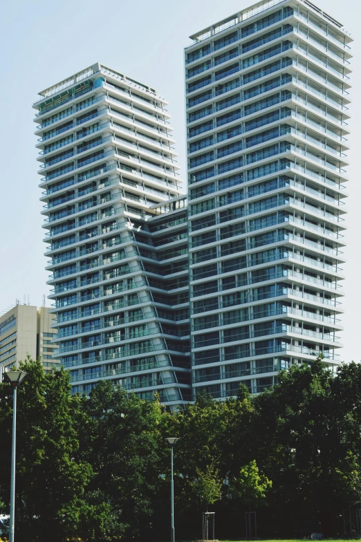 a couple of buildings are on the other side of a grassy area