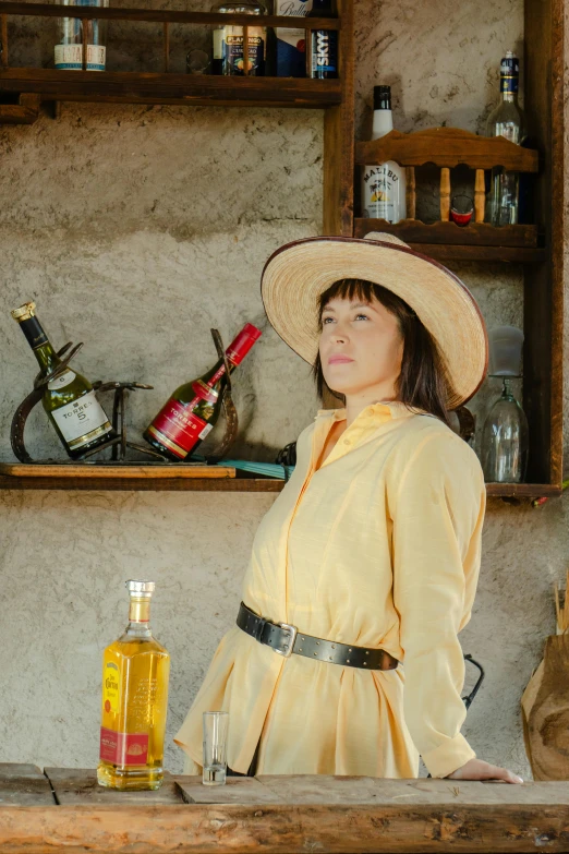 a woman in a yellow dress with a hat