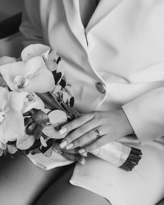 a woman holding a bouquet with many flowers in it