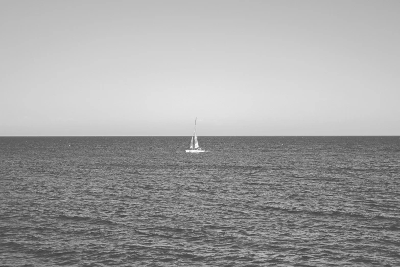 the sail boat is sailing on the open water