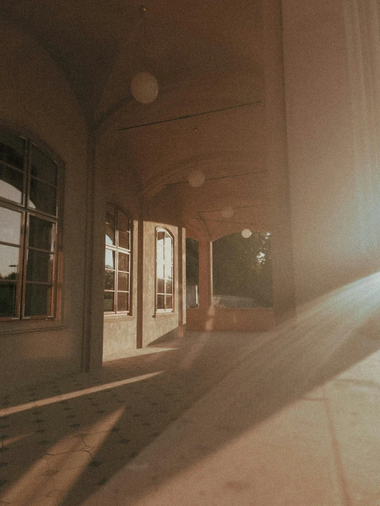 a room with many doors, windows and sunlight coming in from a window