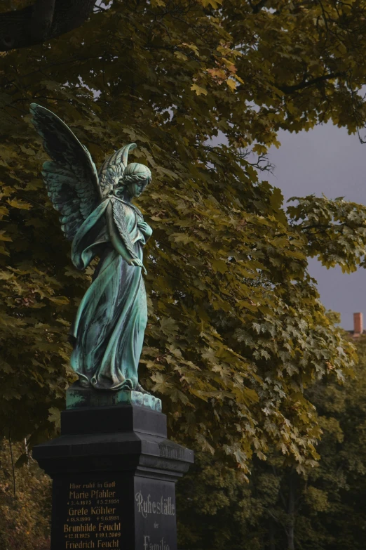 a statue of an angel next to a park