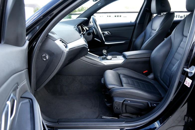 the inside of a small modern vehicle with the door open