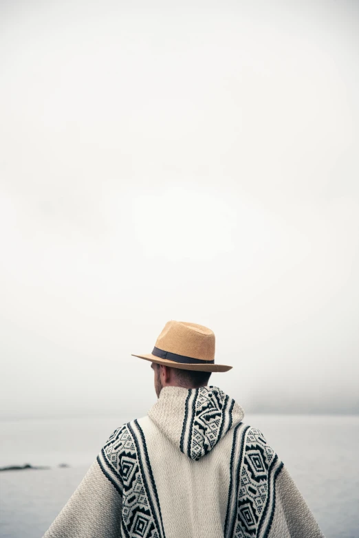 a man in an unusual sweater with a hat on his head