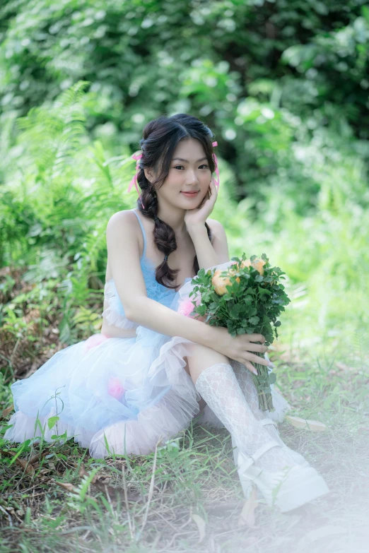 a woman is dressed up in a tutu sitting on the grass