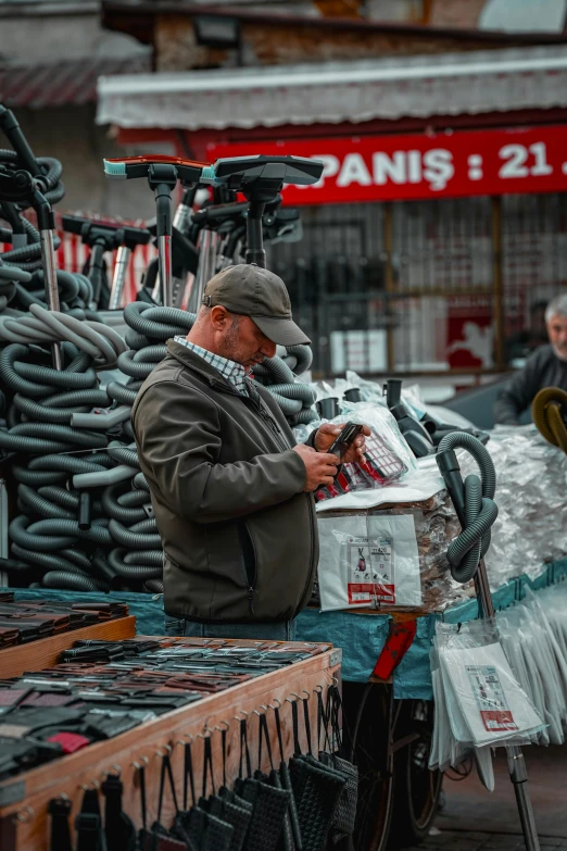 the man in the store is checking soing on the phone